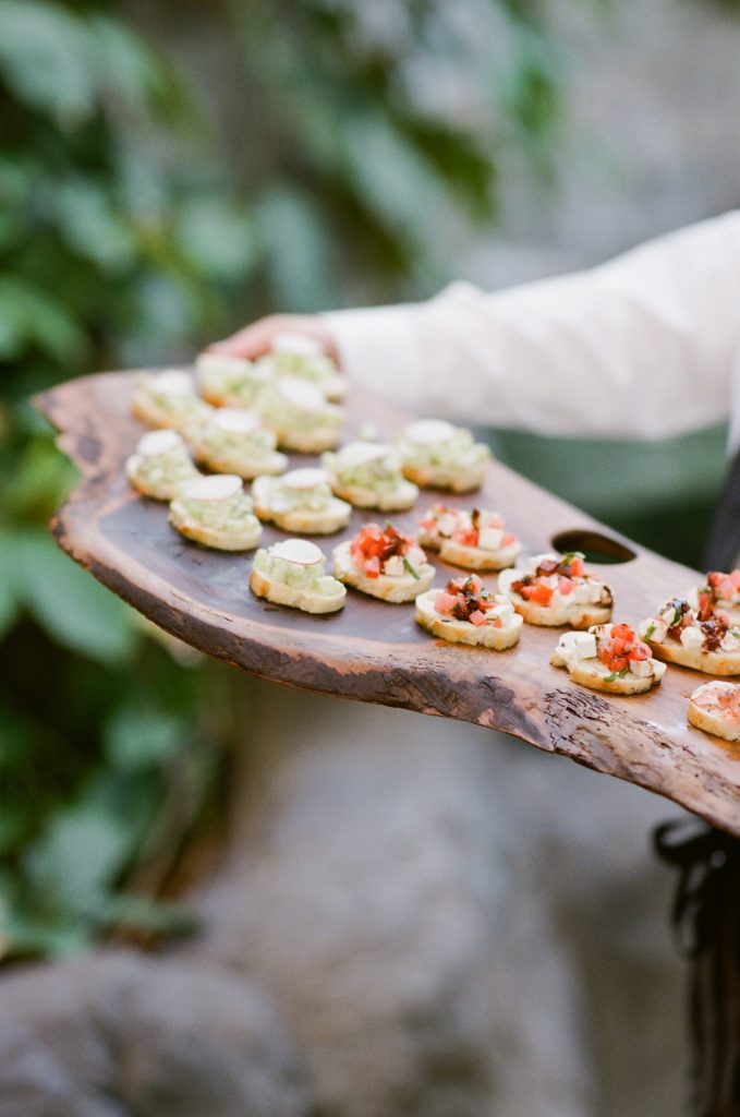 Appetizers on driftwood plank.