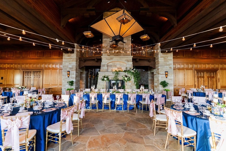 Dinning Setup with blue satin table cloths and pink satin chair bows on chiavari chairs.