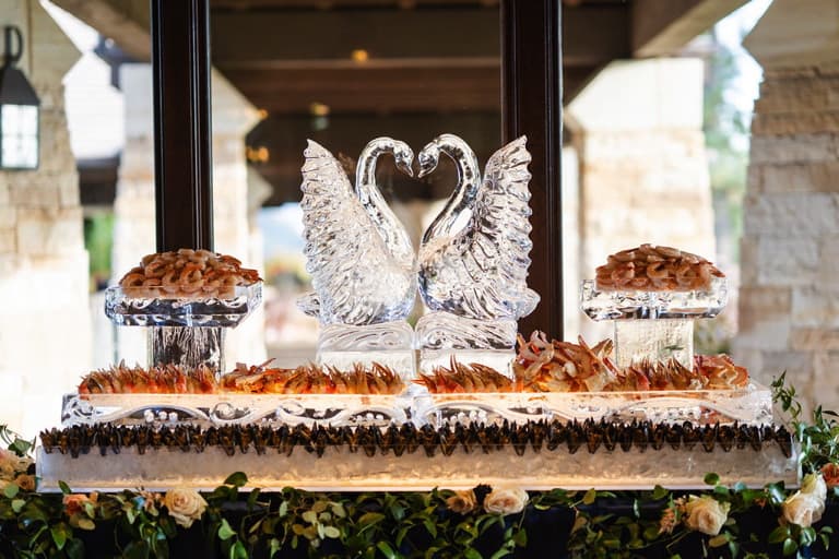 Raw bar with swan ice sculptures.